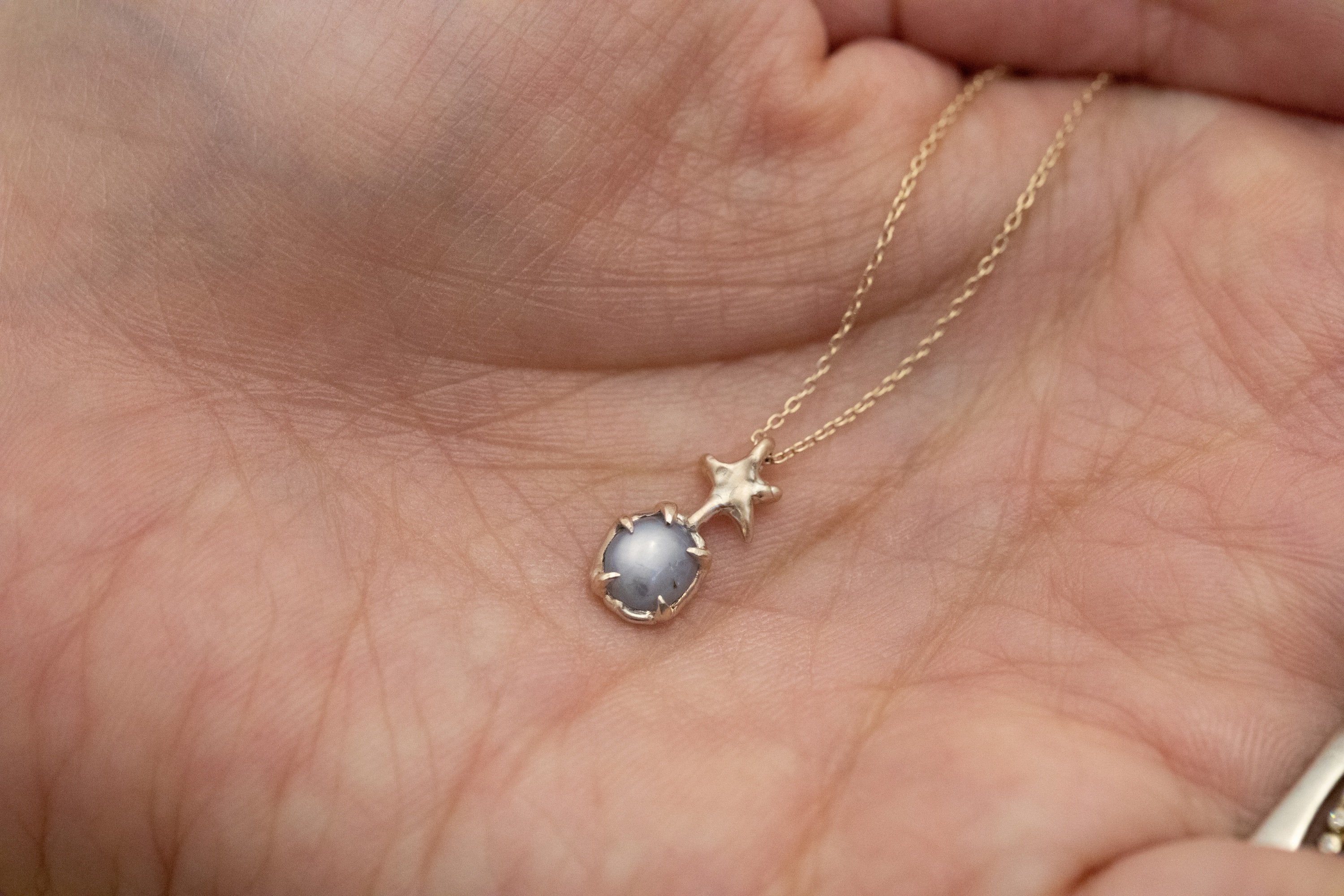 Dancing Star with a Blue Star Sapphire (10k)